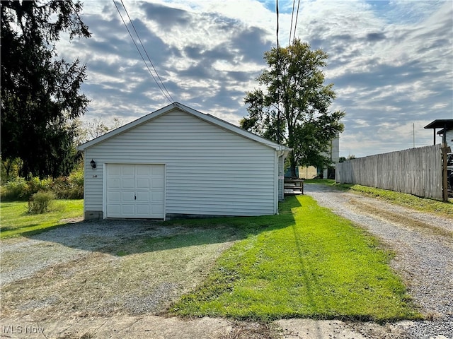 garage featuring a lawn