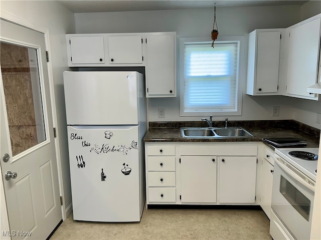 kitchen featuring sink, white appliances, and white cabinetry