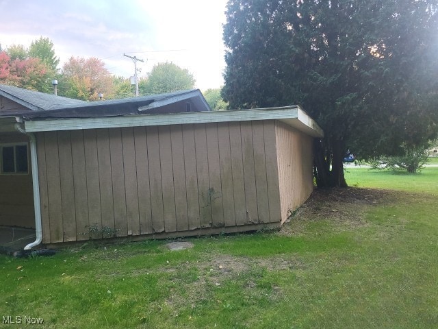 view of outbuilding featuring a yard