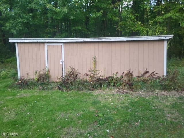 view of outbuilding with a yard