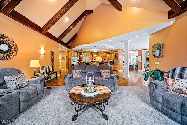 living room featuring high vaulted ceiling, wood-type flooring, beamed ceiling, and decorative columns