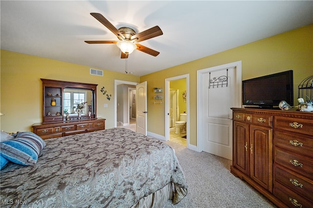 carpeted bedroom with connected bathroom and ceiling fan