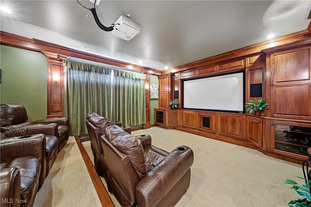 home theater with decorative columns, light colored carpet, and crown molding