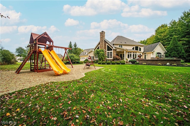 view of playground with a lawn