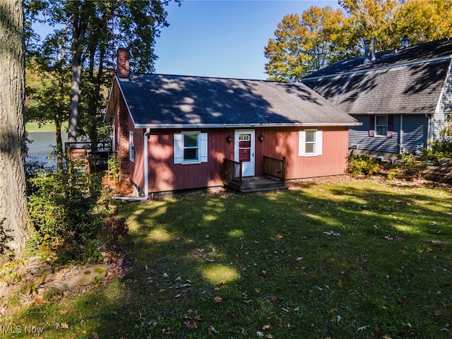 rear view of house with a lawn