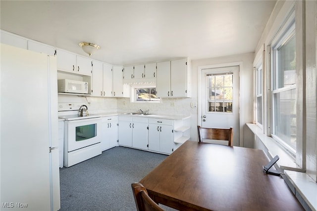 kitchen featuring tasteful backsplash, white appliances, sink, and white cabinetry