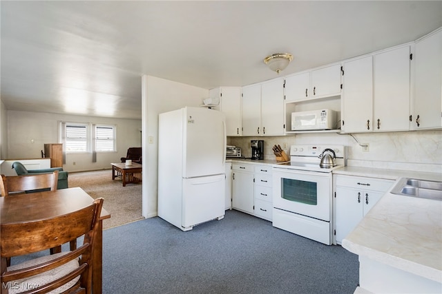 kitchen with dark carpet, white cabinets, white appliances, and decorative backsplash