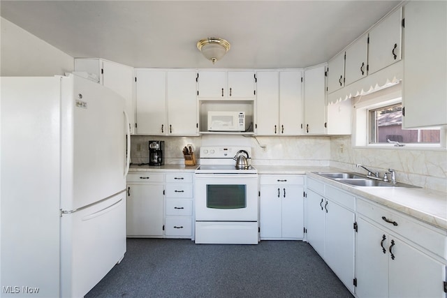 kitchen with tasteful backsplash, white appliances, white cabinets, and sink