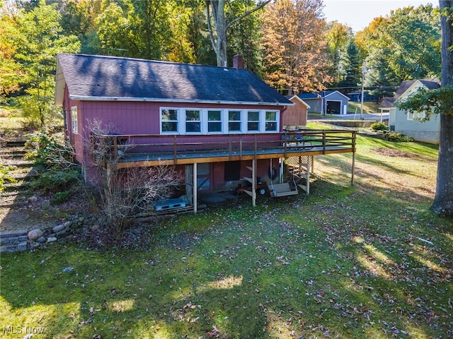 rear view of house with a yard and a wooden deck