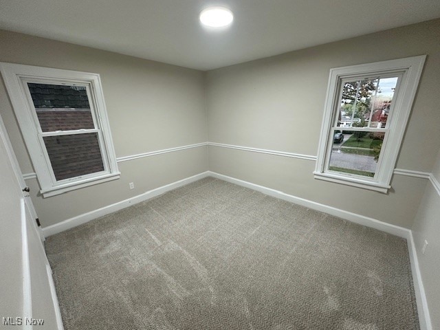 unfurnished room with carpet flooring