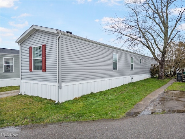 view of property exterior featuring a lawn