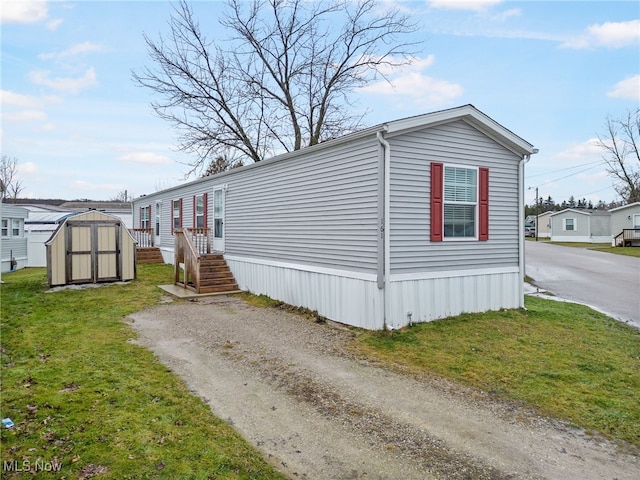 view of side of property featuring a storage shed and a yard