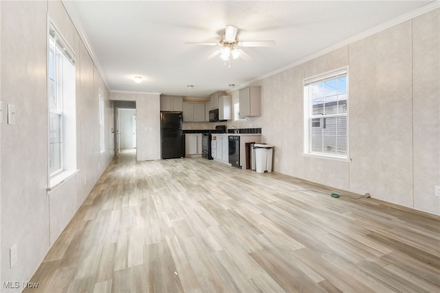 kitchen with black appliances, light hardwood / wood-style floors, and crown molding