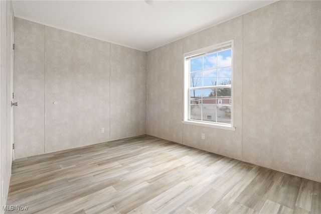 spare room with light hardwood / wood-style floors