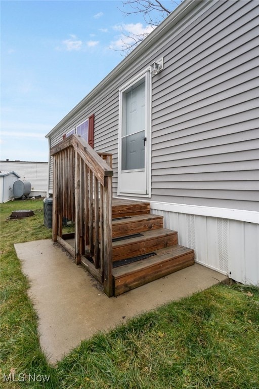 doorway to property featuring a yard