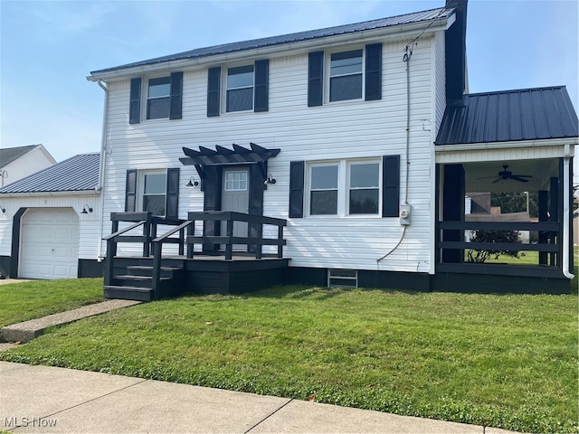 view of front of property featuring a deck, a garage, a front lawn, and ceiling fan