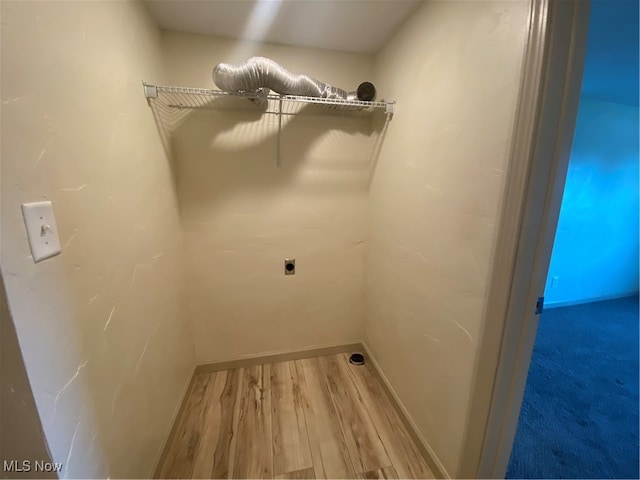 laundry room with wood-type flooring and electric dryer hookup