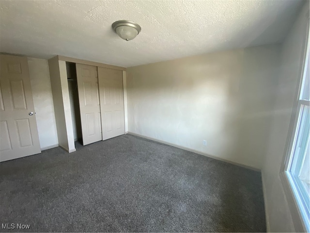 unfurnished bedroom featuring a closet and a textured ceiling