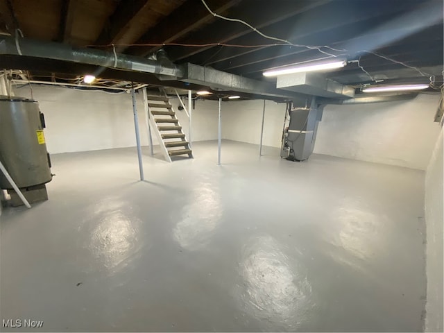 basement featuring water heater and heating unit