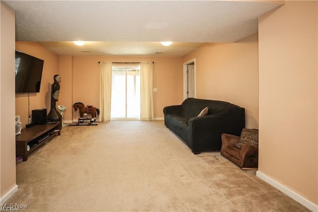 carpeted living room with a textured ceiling