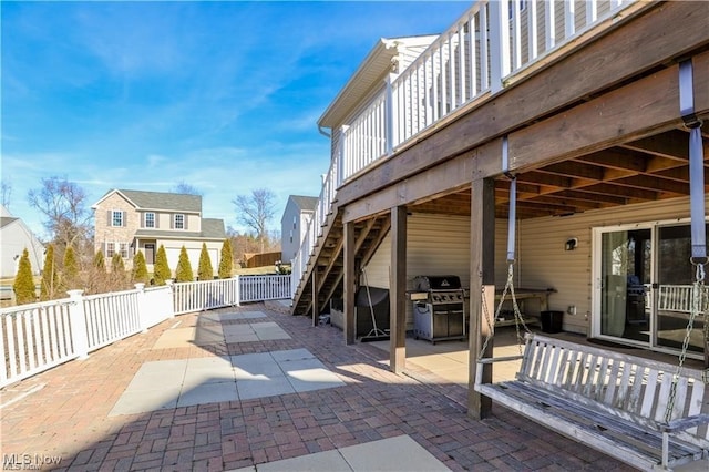 view of patio featuring a wooden deck and a grill