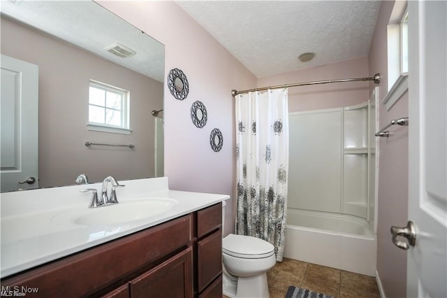 full bathroom featuring tile patterned flooring, shower / tub combo, toilet, vanity, and a textured ceiling