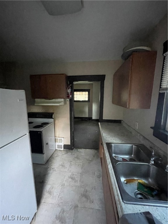 kitchen with ventilation hood, white appliances, and sink