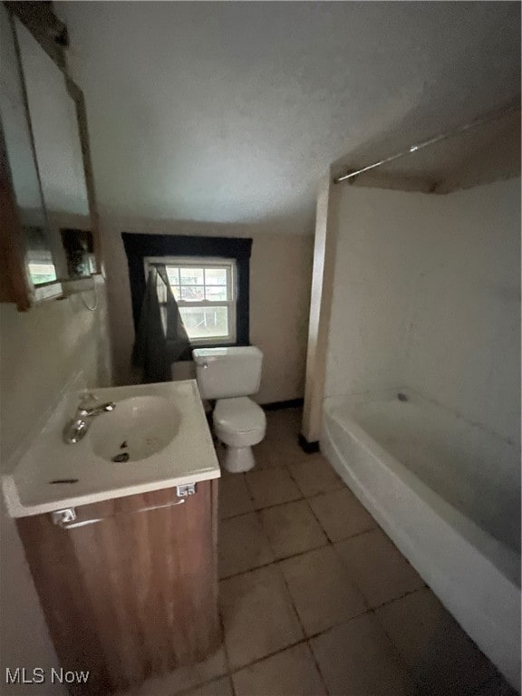 full bathroom featuring tile patterned flooring,  shower combination, vanity, and toilet