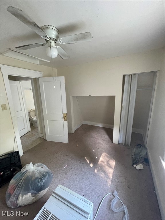 unfurnished bedroom featuring ceiling fan and carpet flooring