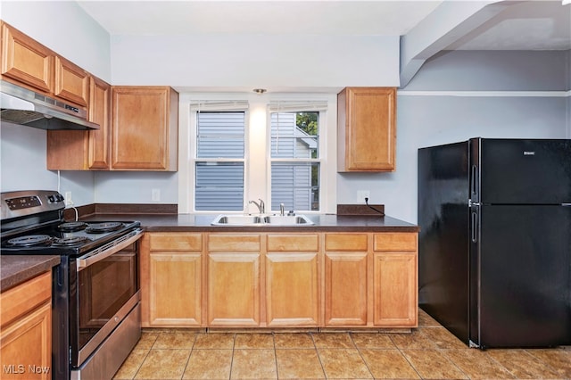 kitchen with stainless steel electric stove, black refrigerator, sink, light tile patterned floors, and extractor fan