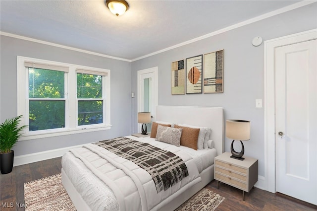 bedroom featuring a textured ceiling, crown molding, and dark wood-type flooring