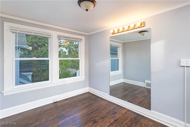 spare room featuring dark hardwood / wood-style flooring and ornamental molding