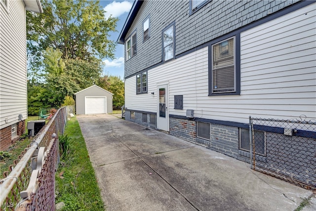 view of side of home with a garage and an outdoor structure