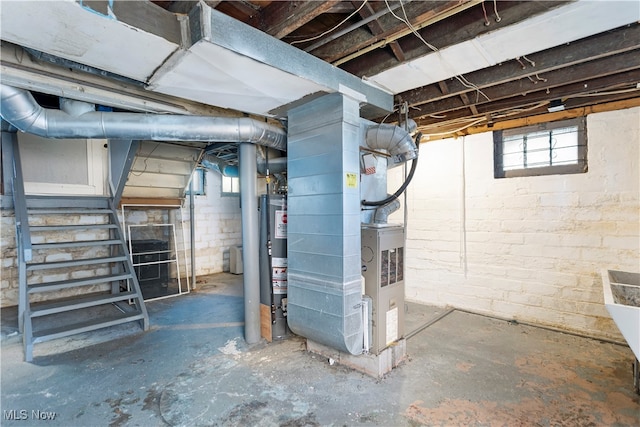 basement featuring gas water heater and heating unit