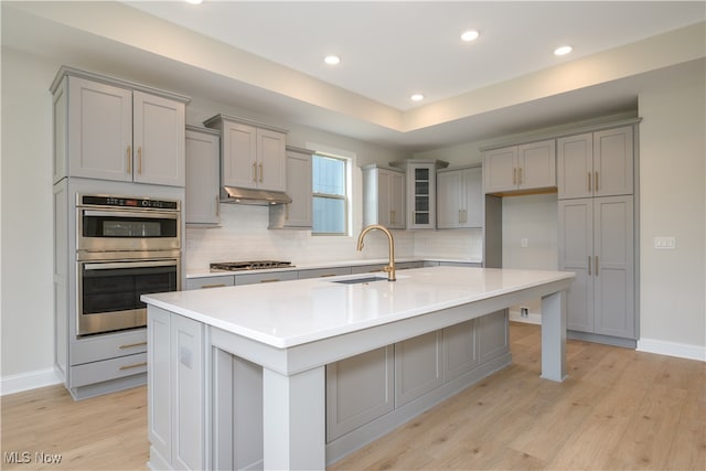 kitchen featuring appliances with stainless steel finishes, sink, and gray cabinets