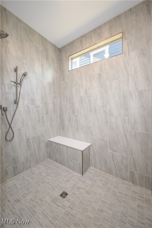 bathroom with tiled shower