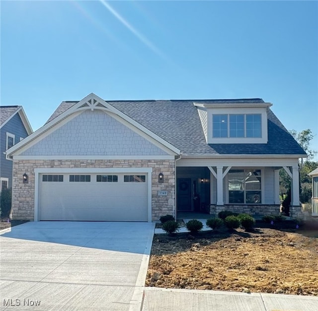 craftsman-style house with covered porch and a garage