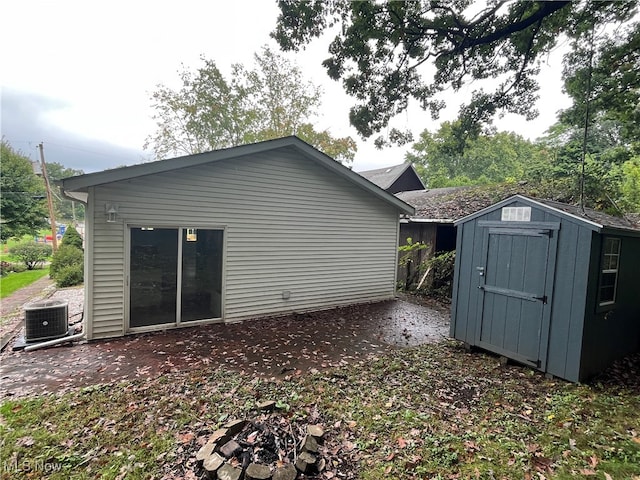 exterior space featuring cooling unit and a storage unit