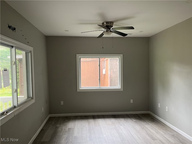 unfurnished room featuring ceiling fan, light hardwood / wood-style floors, and a healthy amount of sunlight