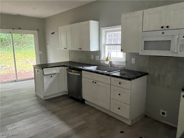 kitchen featuring dishwasher, white cabinets, sink, and light wood-type flooring