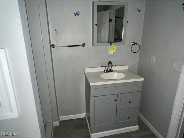 bathroom featuring vanity and hardwood / wood-style floors