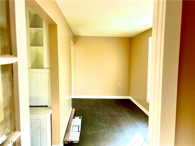 unfurnished room featuring radiator and dark hardwood / wood-style floors