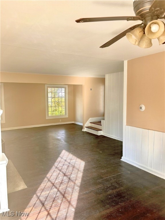 empty room with dark hardwood / wood-style flooring and ceiling fan