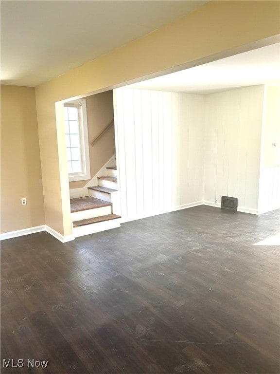 basement with dark hardwood / wood-style floors