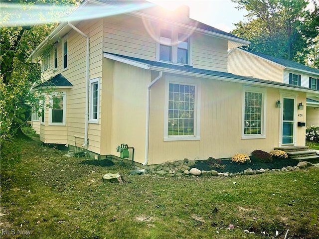 view of side of home featuring a yard