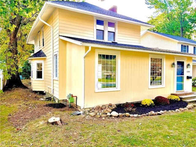 view of side of property with a yard