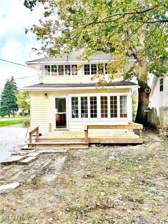 back of property with a wooden deck