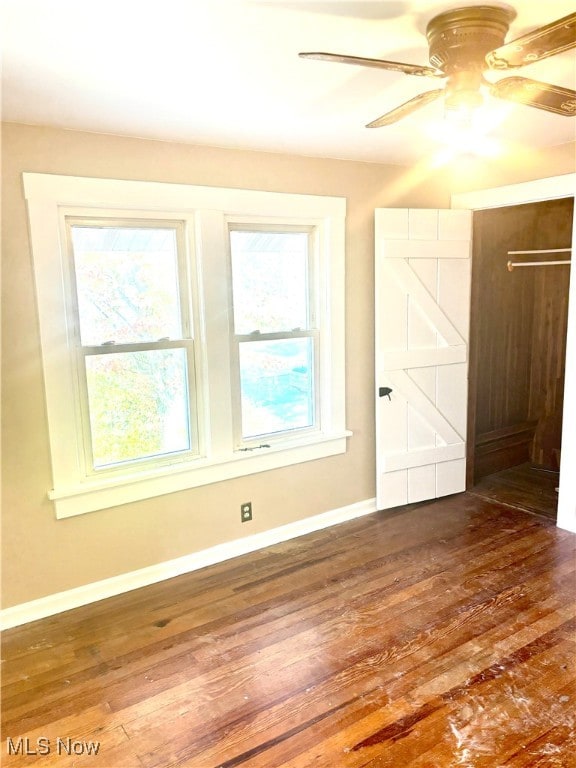 interior space with ceiling fan and dark hardwood / wood-style floors