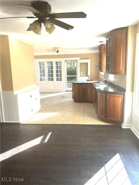 kitchen featuring light wood-type flooring, ceiling fan, and sink