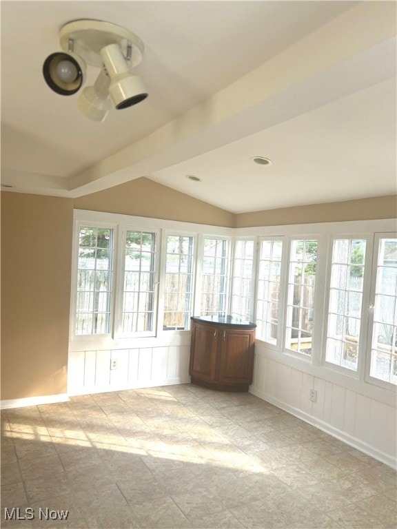 unfurnished sunroom with lofted ceiling and a wealth of natural light